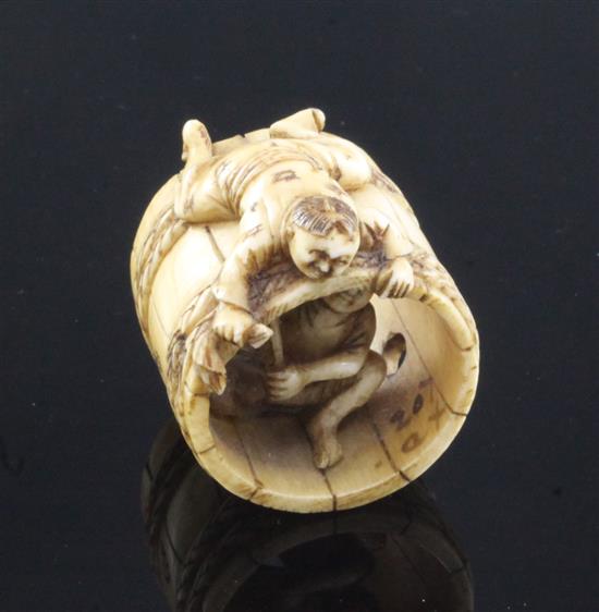 A Japanese ivory netsuke of two men constructing a barrel, Meiji period, 2.8cm